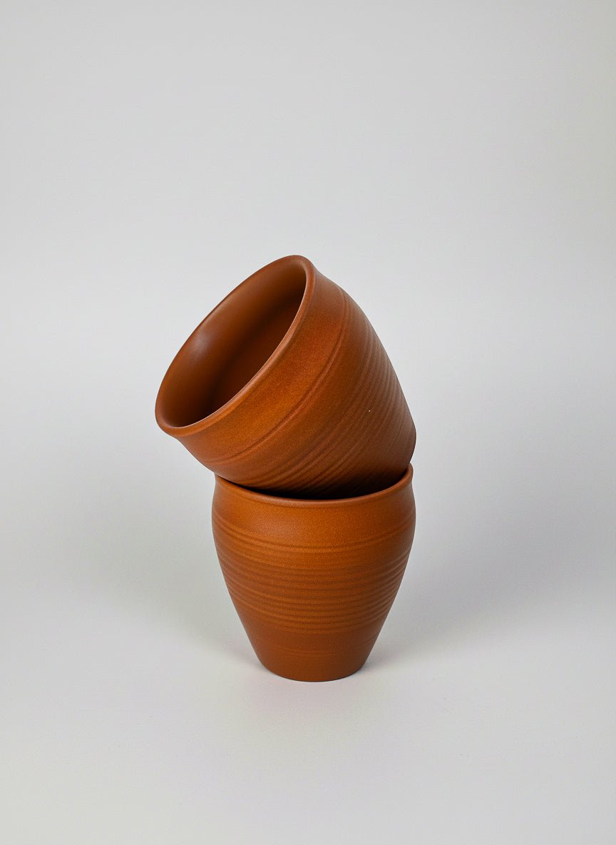 The Khulad Pair of 2, Kurinam handcrafted clay chai cups stacked on a light gray background