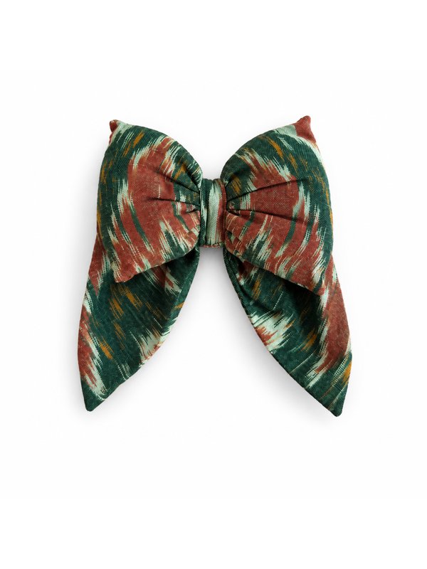 Green Rust Ikat bow, top-down on white