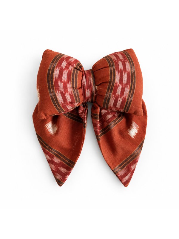 Rust Ikat bow, top-down on white
