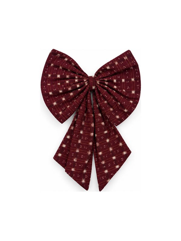Neela Bow in burgundy with gold dots, top-down on white