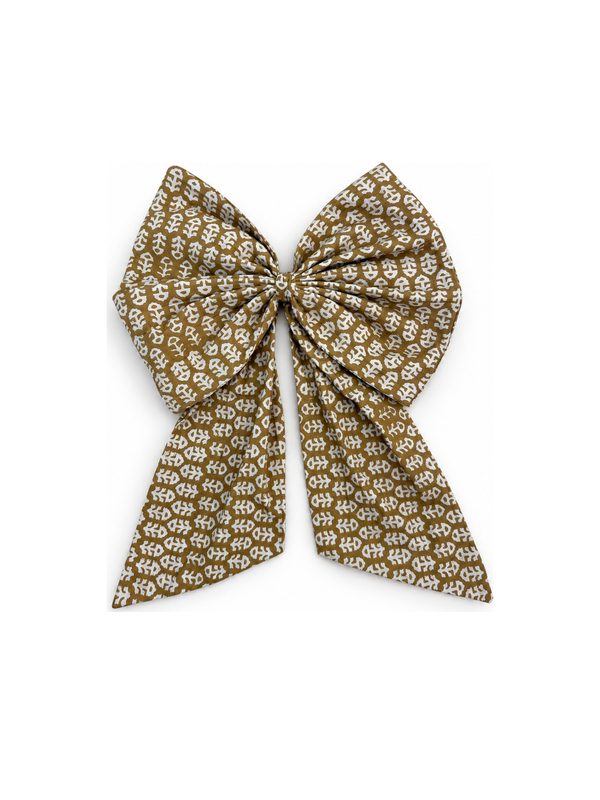 Neela Bow in gold and cream floral, top-down on white