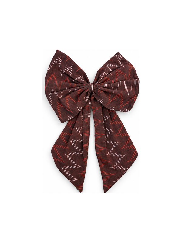 Neela Bow in red zigzag ikat, top-down on white