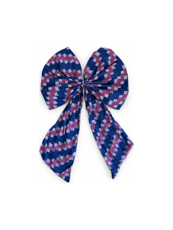 Neela Bow in blue and pink ikat stripe, top-down on white