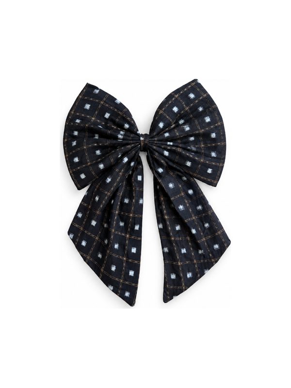 Neela Bow in black with white dots, top-down on white