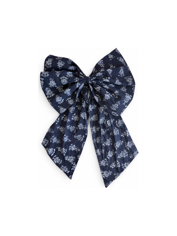 Neela Bow in navy with white flowers, top-down on white